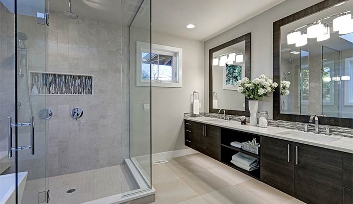 A beautiful bathroom with installed glass shower enclosure