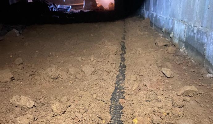 Installing crawl-space drain pipe