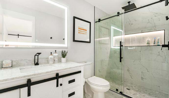 A sleek bathroom featuring a glass-enclosed rainfall shower